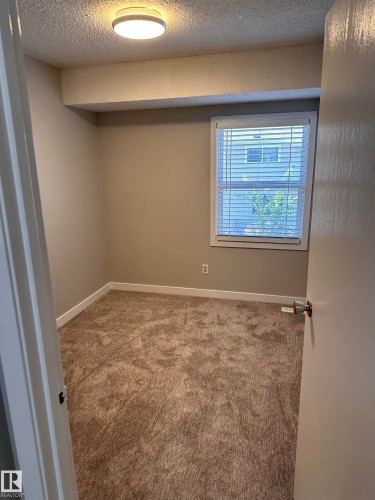 Neutral wall paint, carpet flooring, single window with blinds, overhead flush mount lighting, and white trim - 9G Clareview Village Nw, Edmonton, AB 
