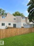 Expansive green lawn with a wood privacy fence - 9G Clareview Village Nw, Edmonton, AB 