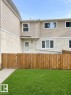 Exterior with horizontal siding, stucco lower facade, and a wood fence enclosing a lawn area - 9G Clareview Village Nw, Edmonton, AB 
