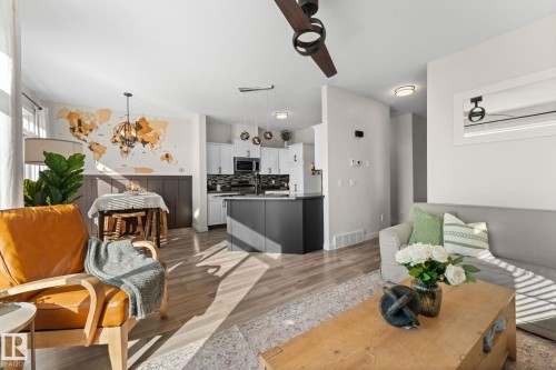 Open-concept living space with wood-finish flooring - #5 4900 62 St, Beaumont, AB 