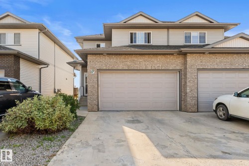 Two-story exterior with light brick and horizontal siding - #5 4900 62 St, Beaumont, AB 