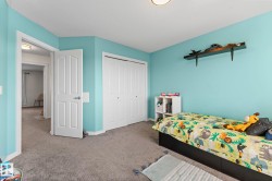 Carpeted flooring, white trim, and a white bi-fold closet door - 