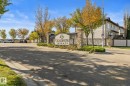 Goudreau Terrace entry sign with stone pillars and wrought iron accents - #5 4900 62 St, Beaumont, AB 