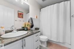 Vanity with integrated sink, chrome faucet, and dark-toned countertop - 