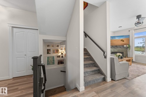 Carpeted staircase with dark handrail - #5 4900 62 St, Beaumont, AB 