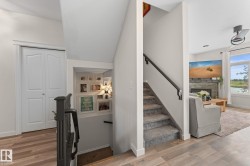 Carpeted staircase with dark handrail - 
