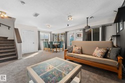 Carpeted lower level with recessed lighting, an interior staircase, and sliding glass doors - 