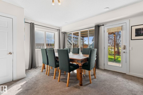 Recessed ceiling lighting, carpeted flooring, white paneled doors, and a glass-paned exterior door - #5 4900 62 St, Beaumont, AB 