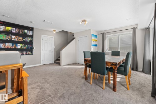 Carpeted flooring throughout, recessed lighting, and a window with blinds and drapes - #5 4900 62 St, Beaumont, AB 