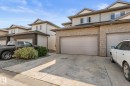 Brick and siding exterior with multiple garage doors and concrete driveways - #5 4900 62 St, Beaumont, AB 
