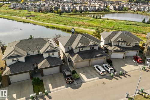 Detached property with a dual-pitched roof, attached two-car garage, and a paved driveway - #5 4900 62 St, Beaumont, AB 