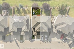 Gable roof residence featuring an attached garage and a fenced backyard with a manicured lawn - 