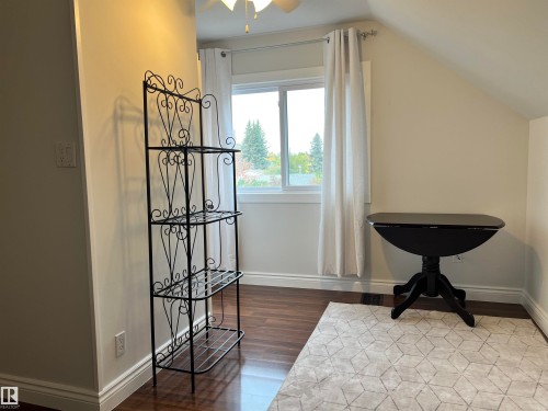Wood-finish flooring with crisp white baseboards and neutral wall tones - 11908 131 Street Nw, Edmonton, AB 