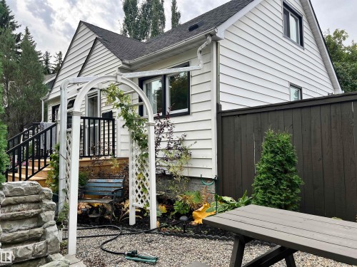 White horizontal siding exterior with black trim windows - 11908 131 Street Nw, Edmonton, AB 