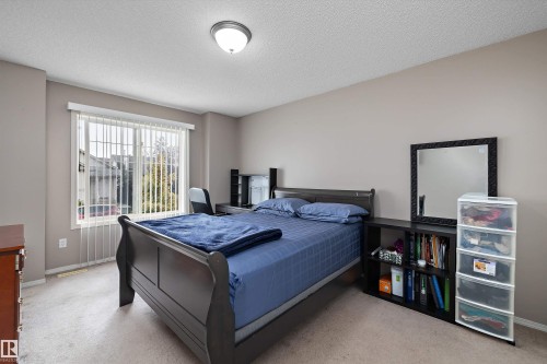 Neutral tone wall finishes, carpeting, and a window with vertical blinds - 3114 32 Avenue Nw, Edmonton, AB 