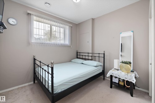 Wall-mounted lighting fixture, window with security bars, vertical blinds, and a built-in access panel - 3114 32 Avenue Nw, Edmonton, AB 