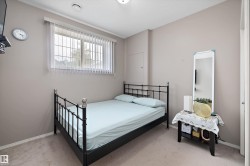 Wall-mounted lighting fixture, window with security bars, vertical blinds, and a built-in access panel - 