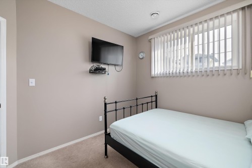 Carpeted flooring, window with vertical blinds, and neutral wall tones - 3114 32 Avenue Nw, Edmonton, AB 