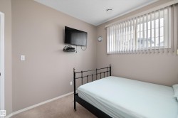 Carpeted flooring, window with vertical blinds, and neutral wall tones - 