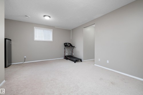 Recessed window with white blinds, neutral wall paint, and light-colored carpeting - 3114 32 Avenue Nw, Edmonton, AB 