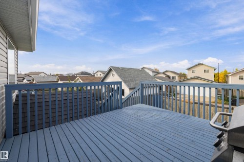 Elevated outdoor deck with painted wood railing and decking - 3114 32 Avenue Nw, Edmonton, AB 