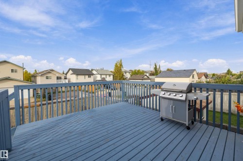 Expansive outdoor deck with painted wood flooring and railing - 3114 32 Avenue Nw, Edmonton, AB 