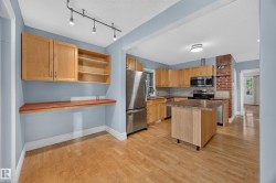 Wood-finish flooring throughout, with a kitchen island featuring a wood-finish countertop - 
