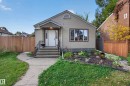 Siding exterior featuring a front entry with concrete steps and wrought iron railings - 9615 75 Avenue Nw, Edmonton, AB 