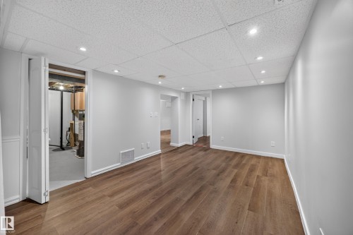 Wood-finish flooring, recessed lighting, drop ceiling, white trim, and light gray walls - 9615 75 Avenue Nw, Edmonton, AB 