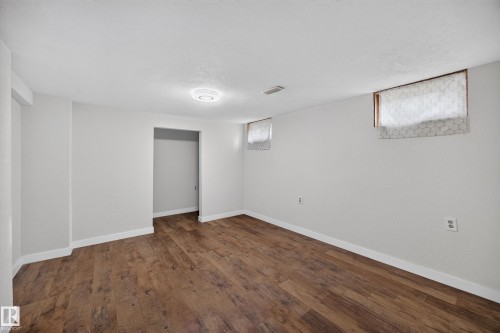 Room featuring wood-finish flooring, recessed lighting, and white baseboards - 9615 75 Avenue Nw, Edmonton, AB 
