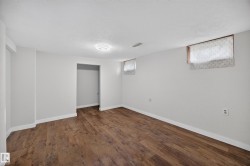 Room featuring wood-finish flooring, recessed lighting, and white baseboards - 