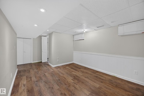 Wood-finish flooring, recessed lighting, drop ceiling, bi-fold closet doors, and wall-mounted air conditioning units - 9615 75 Avenue Nw, Edmonton, AB 