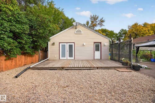 Exterior with horizontal siding, a gabled roofline, a wooden deck, and a gravel ground cover - 9615 75 Avenue Nw, Edmonton, AB 