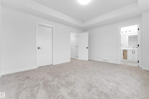 Recessed ceiling, light-toned carpet, and white walls - 525 Robinson Blvd, Leduc, AB 