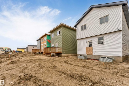 Two-story siding exterior with multiple window openings and a rear door - 525 Robinson Blvd, Leduc, AB 