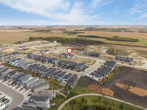 Aerial perspective showcasing a residential development with varied housing styles - 525 Robinson Blvd, Leduc, AB 