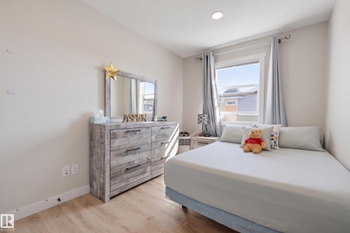 Recessed lighting, light wood-finish flooring, and a large window - #3 150 Everitt Dr N, St. Albert, AB 