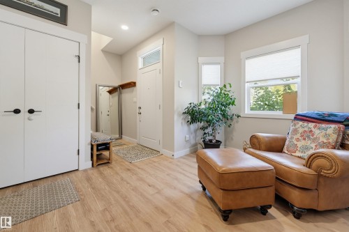 Wood-finish flooring, white trim, recessed lighting, and ample natural light from multiple windows - #3 150 Everitt Dr N, St. Albert, AB 