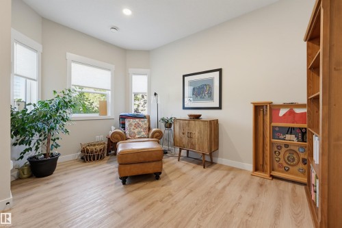 Wood-finish flooring, multiple windows with white trim, recessed ceiling lighting, and light-toned walls - #3 150 Everitt Dr N, St. Albert, AB 