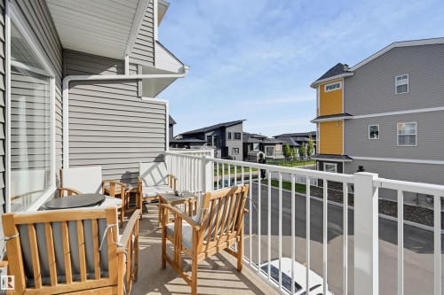 Balcony featuring concrete flooring, a white railing, and grey horizontal siding - #3 150 Everitt Dr N, St. Albert, AB 