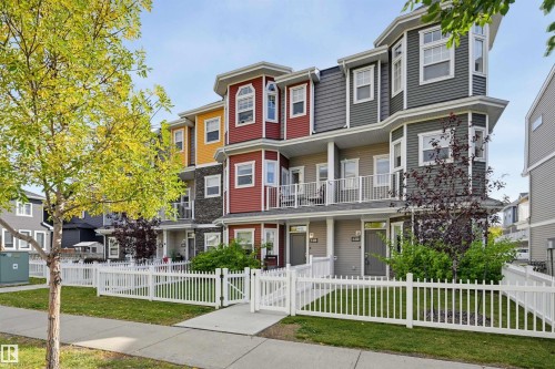 Colorful multi-story townhomes with bay windows, private balconies, and white picket fences - #3 150 Everitt Dr N, St. Albert, AB 