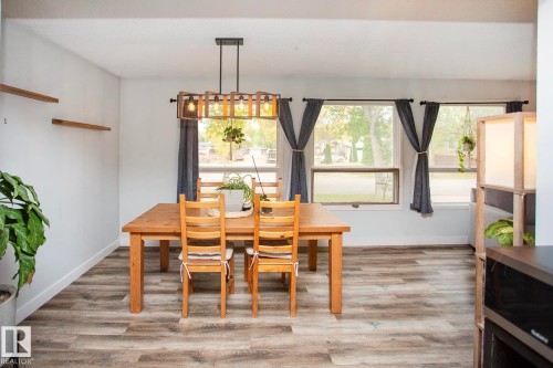 Recessed ceiling, wood-finish flooring, and a linear chandelier - 8 Ash Crescent, St. Albert, AB 