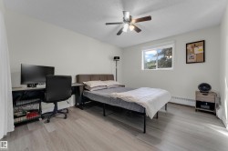 Neutral color palette, wood-finish flooring, ceiling fan, and window with natural light - 