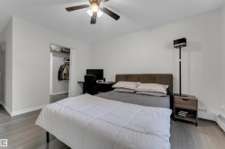 Recessed closet area, ceiling fan with integrated lighting, and wood-finish flooring - 