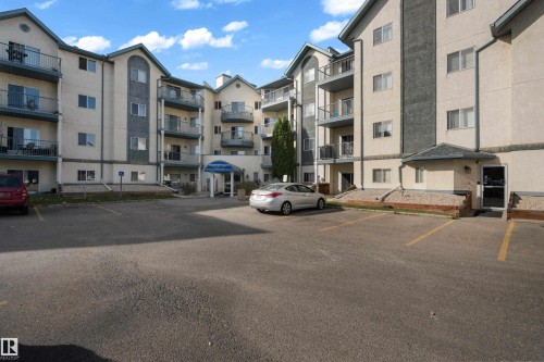 Multi-story building featuring stucco and stone-look exterior accents - #113 2508 50 St Nw, Edmonton, AB 