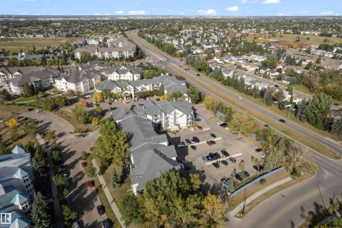 Expansive property featuring multiple multi-story residential buildings, ample surface parking, and mature landscaping - #113 2508 50 St Nw, Edmonton, AB 