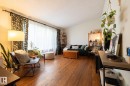 Vaulted ceiling, wood-finish flooring, large window with curtain rods, and built-in shelving - 10972 157 Street Nw, Edmonton, AB 