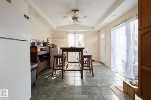 Tiled flooring, vaulted ceiling, recessed lighting, ceiling fan, and a white entry door - 10972 157 Street Nw, Edmonton, AB 