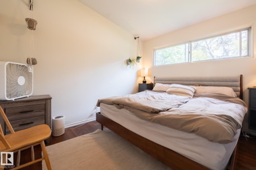 Wood-finish flooring with a neutral area rug - 10972 157 Street Nw, Edmonton, AB 