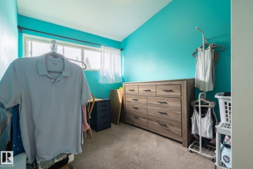 Wall-to-wall carpeting and a multi-pane window with sheer white curtains - 10972 157 Street Nw, Edmonton, AB 